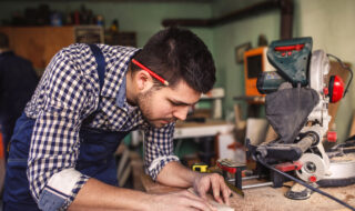 Handsome carftsman working in a work shop.