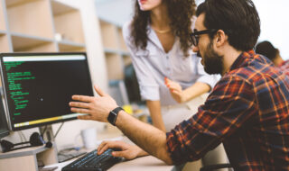 Young software engineers working on project and programming in company