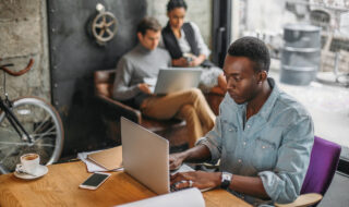 Young designer working at a laptop in the office