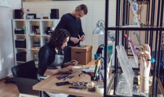 Masters who make jewelry from Venetian glass in their workshop