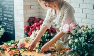 Small business. Male florist unfocused in flower shop. Floral design studio, making decorations and arrangements. Flowers delivery, creating order