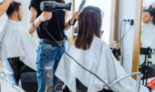 woman drying hair in hair salon