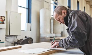 Portrait of a busy craftsman working at his workstation