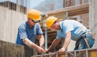 Construction workers working on cement formwork frames