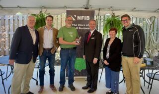The Fickle Pickle owner Andy Badgett presents the NFIB Guardian of Small Business Award to Georgia state Sen. John Albers.