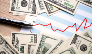 dollars with document showing us financial profits