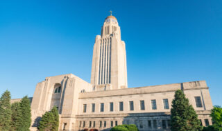 Capitol of Nebraska, Lincoln. The building was designed by Bertram Grosvenor Goodhue and constructed between 1922 and 1932. The Indiana limestone structure draws on both Classical and Gothic architectural traditions, but represents major innovations in state capitol design.