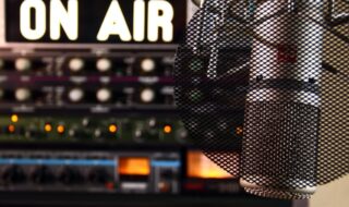 Radio Microphone with an on air sign in the bacjkground