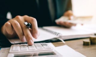 Small Business Owner Calculates Taxes Finance Expensive Inventory Inflation Cost