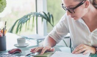 Young women using a calculator at a desk